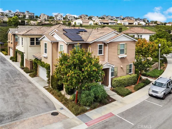 an aerial view of a house with a yard and garage