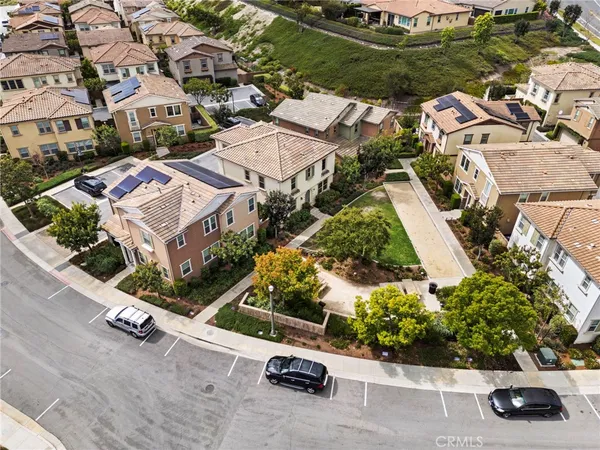 an aerial view of multiple houses with yard