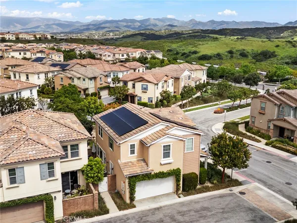 an aerial view of residential houses with outdoor space and ocean view