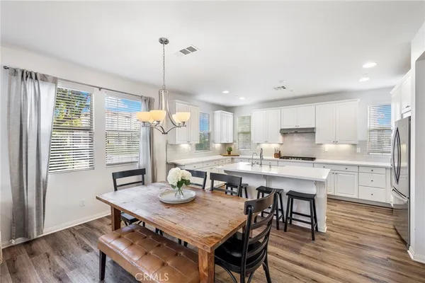 a kitchen with a table and chairs in it
