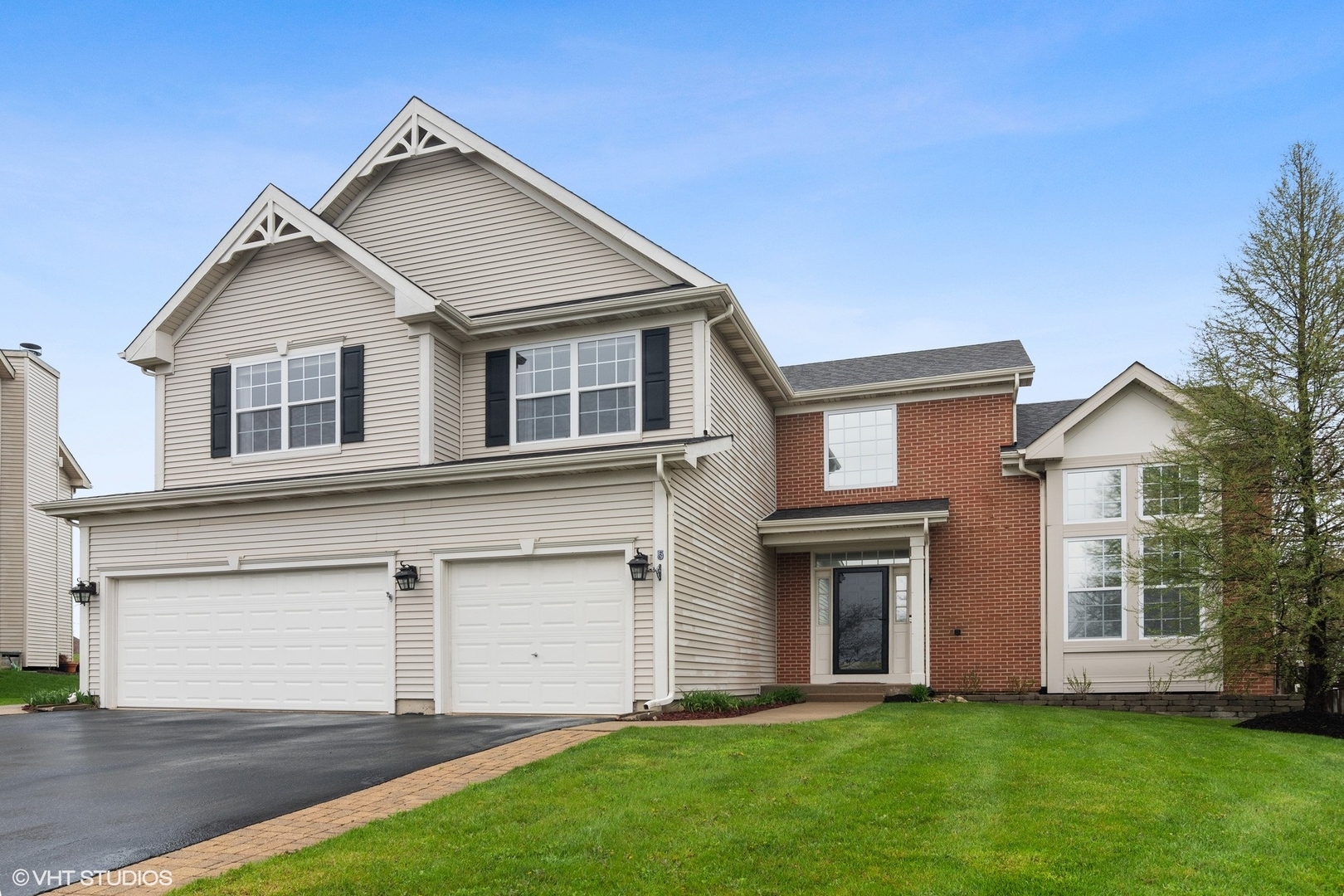 a front view of a house with a yard and garage