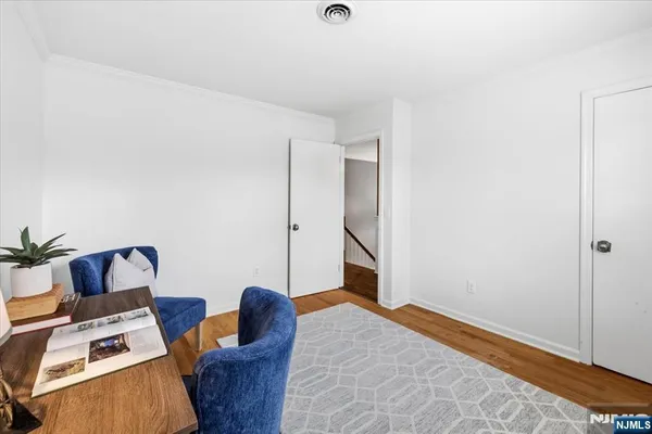 a view of a livingroom with furniture a flat screen tv and floor to ceiling window