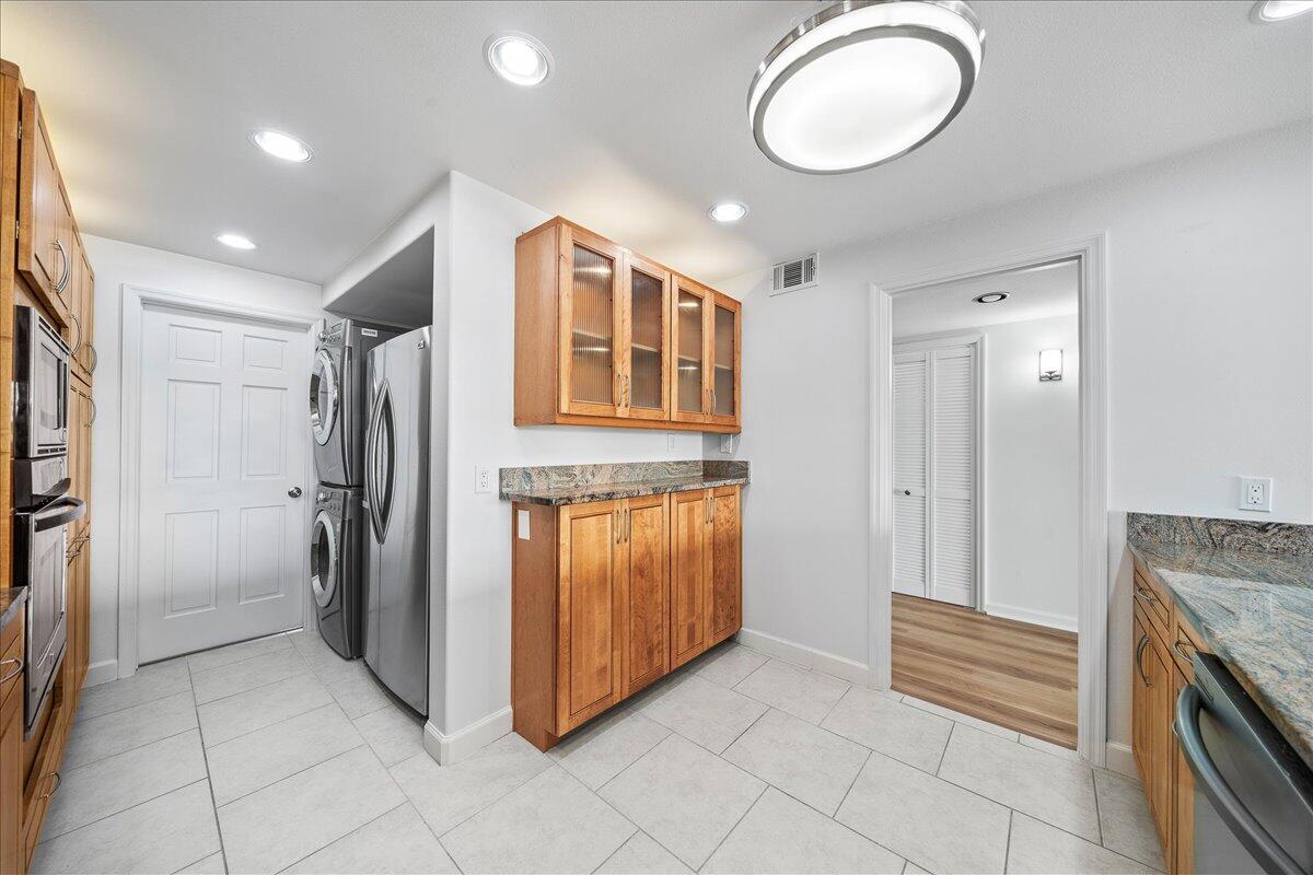 2220 Front Street, Unit 402 Melbourne, FL 32901 - Photo 13 of 26 a bathroom with a granite countertop sink and a mirror