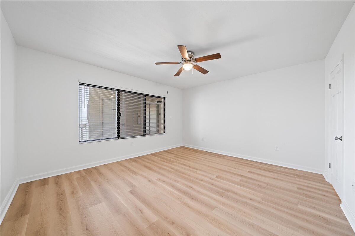 2220 Front Street, Unit 402 Melbourne, FL 32901 - Photo 17 of 26 a view of empty room with wooden floor and fan