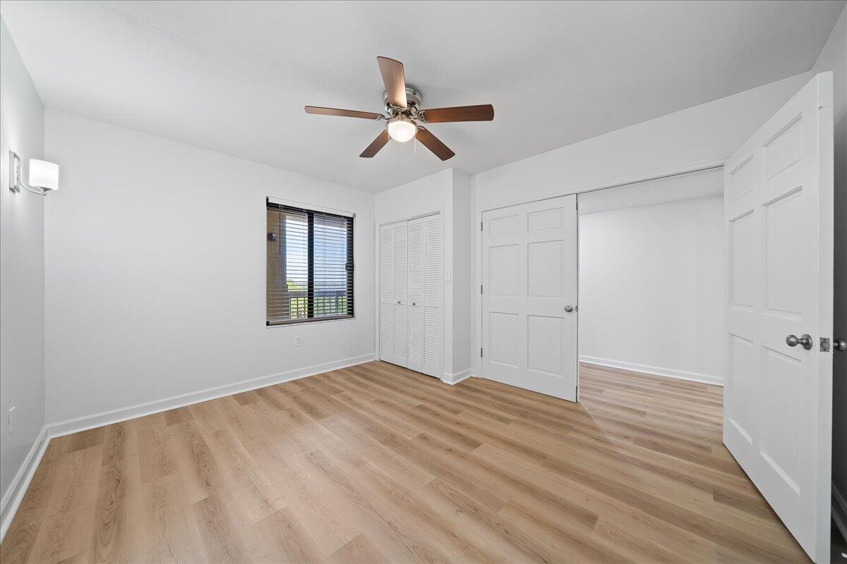 2220 Front Street, Unit 402 Melbourne, FL 32901 - Photo 7 of 26 a view of empty room with wooden floor and fan