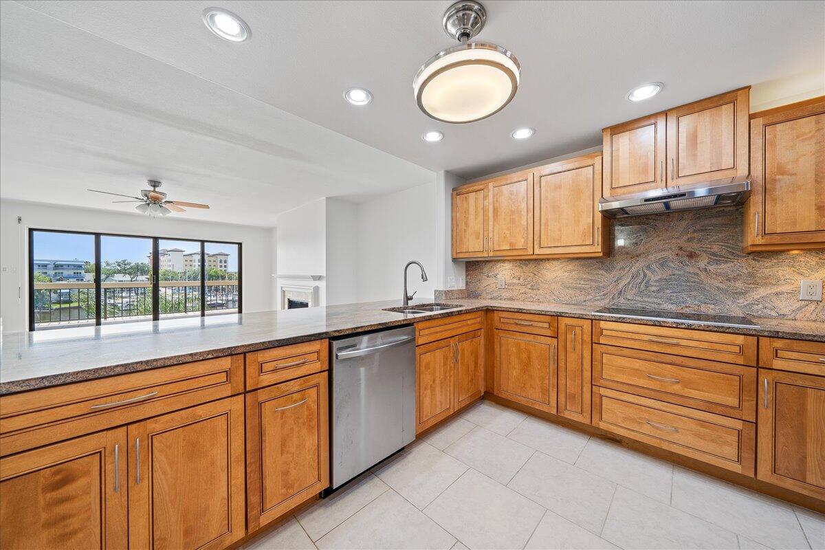 2220 Front Street, Unit 402 Melbourne, FL 32901 - Photo 9 of 26 a large kitchen with stainless steel appliances granite countertop a sink and cabinets