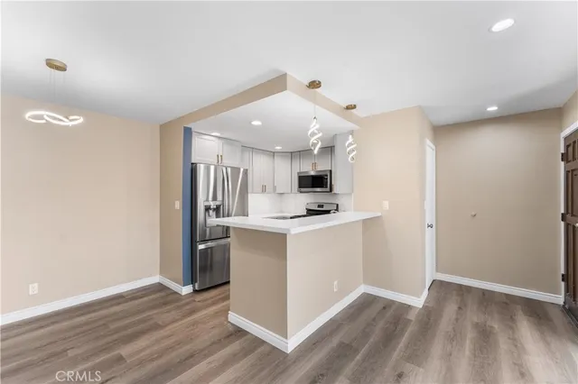 a view of kitchen with stainless steel appliances cabinets