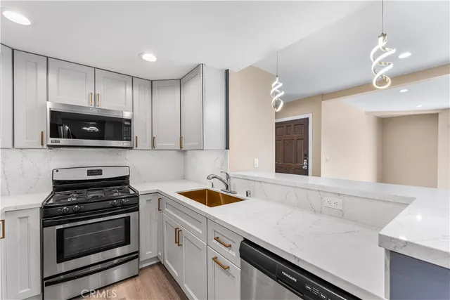 a kitchen with a sink stove and microwave