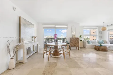 a living room with furniture and a dining table with kitchen view
