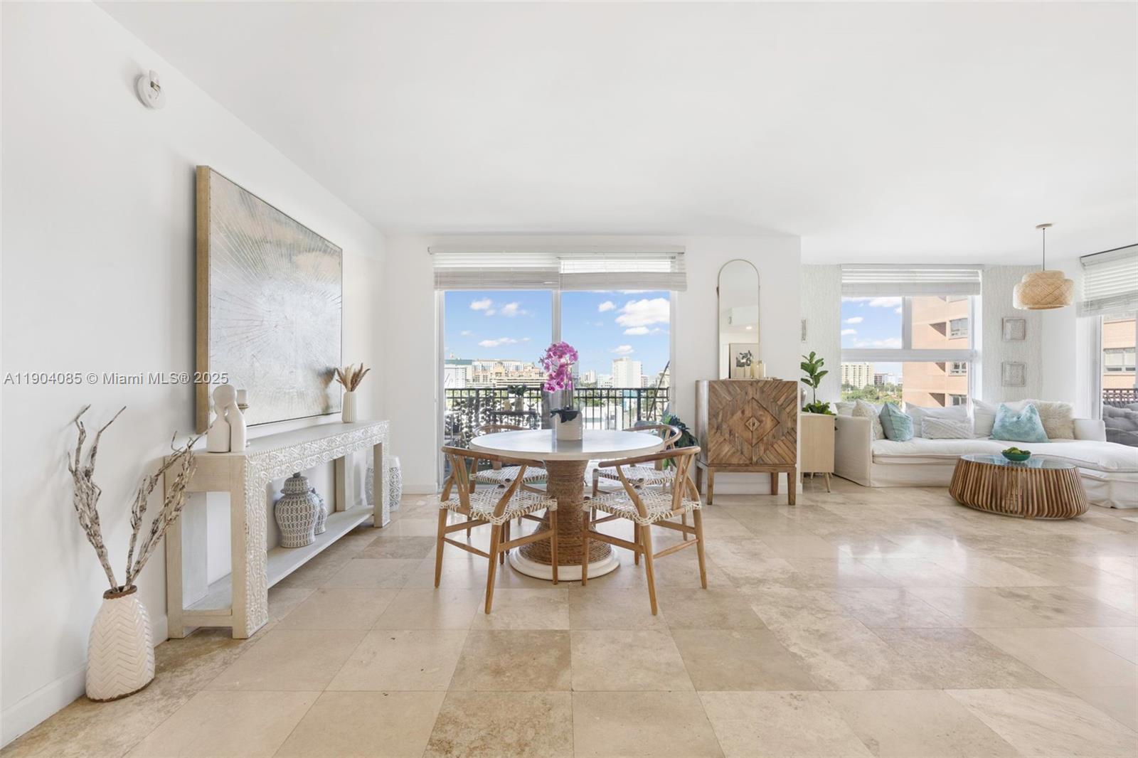 2650 Southwest 37th Avenue, Unit 801 Miami, FL 33134 - Photo 1 of 23 a living room with furniture and a dining table with kitchen view