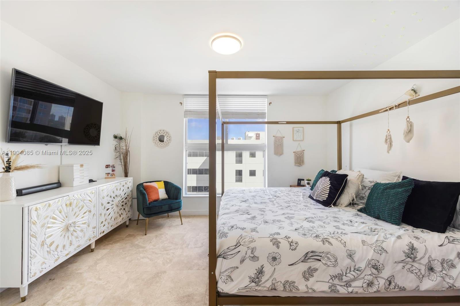 2650 Southwest 37th Avenue, Unit 801 Miami, FL 33134 - Photo 13 of 23 a bedroom with a bed and flat tv screen on the dresser