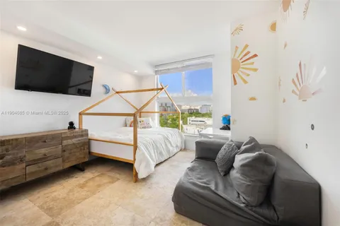 a bedroom with furniture and a flat screen tv