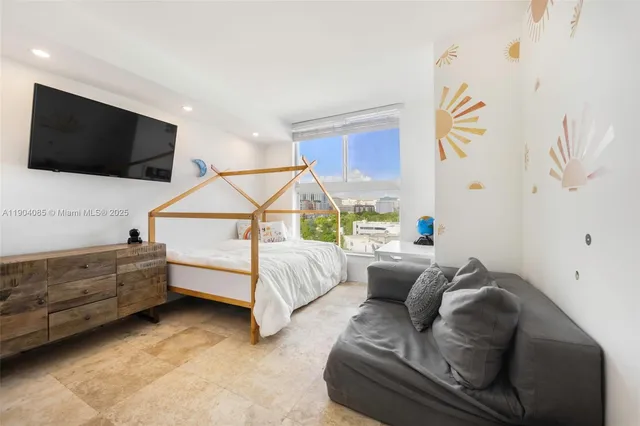 a bedroom with furniture and a flat screen tv