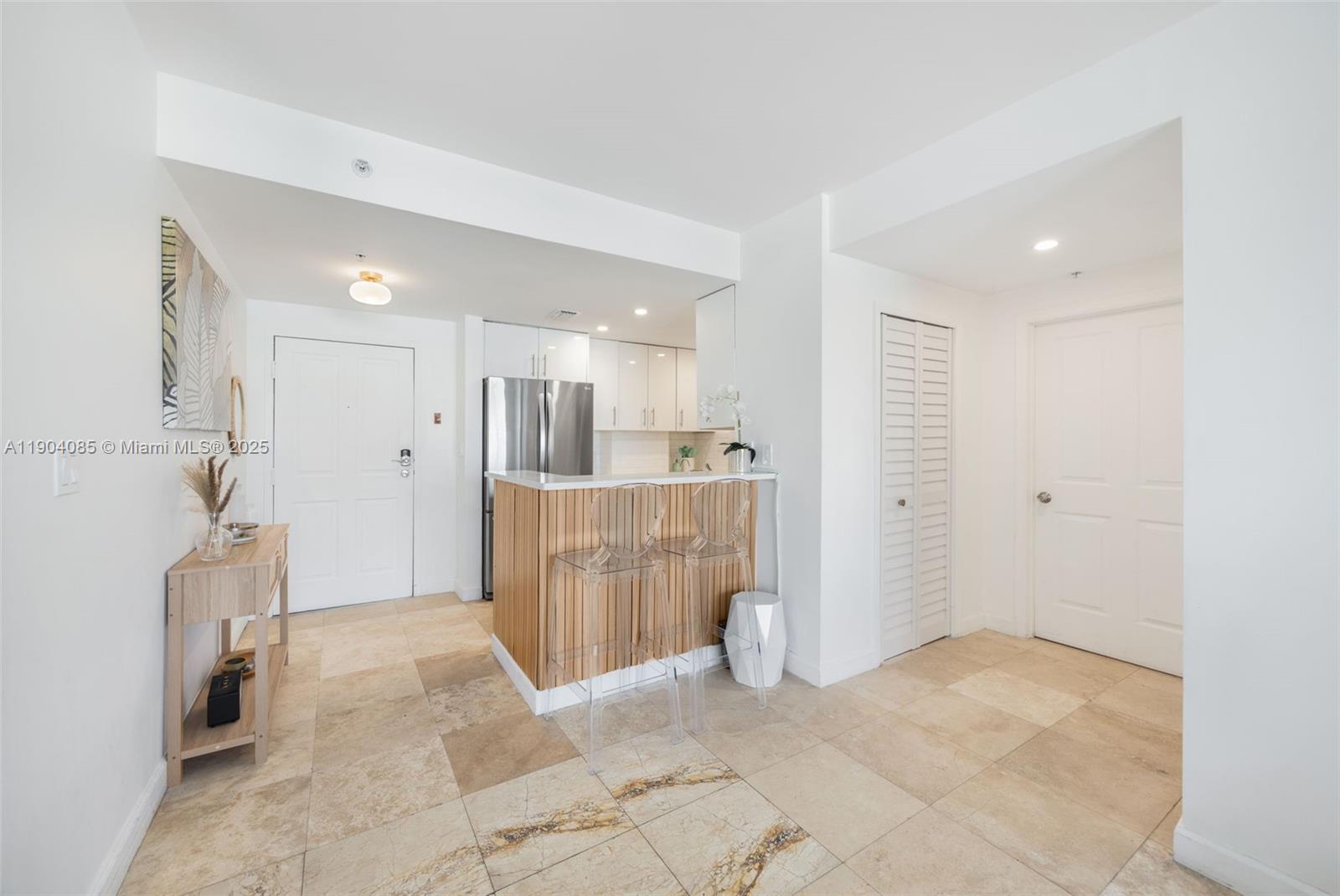 2650 Southwest 37th Avenue, Unit 801 Miami, FL 33134 - Photo 4 of 23 a view of a hallway with a kitchen