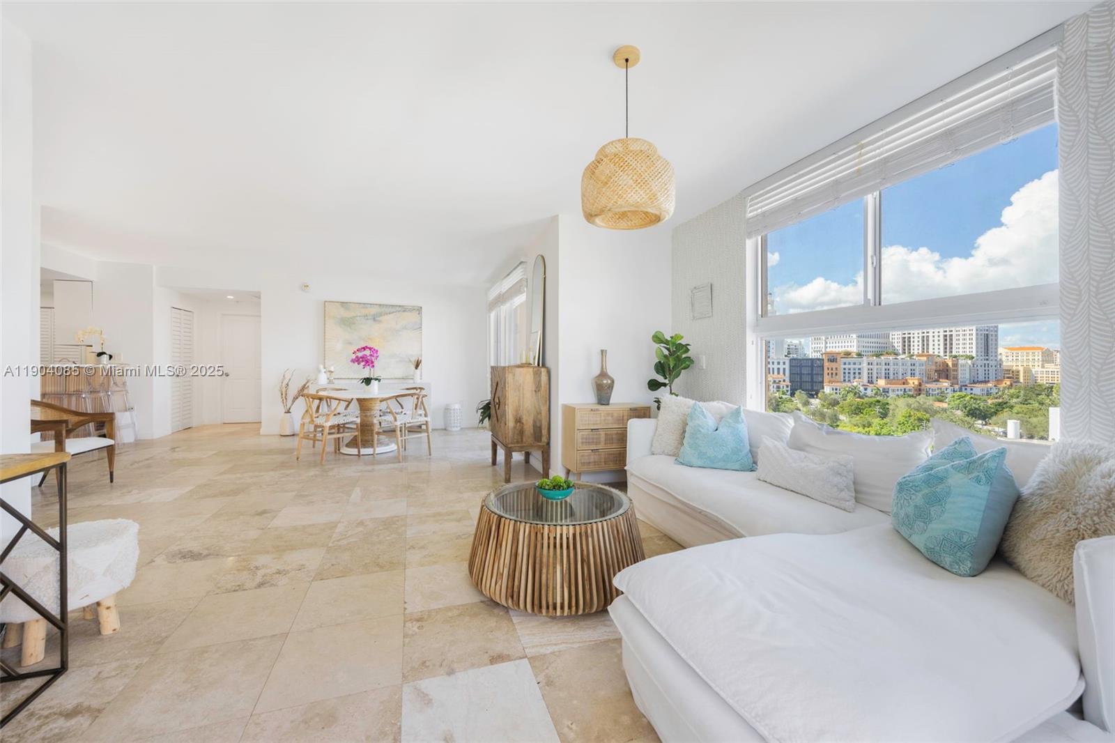 2650 Southwest 37th Avenue, Unit 801 Miami, FL 33134 - Photo 10 of 23 a living room with furniture a chandelier and a large window