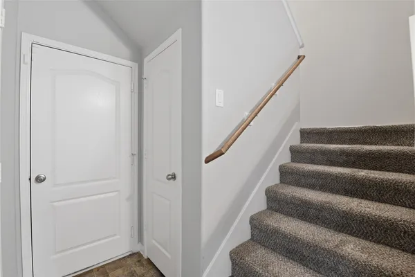 a view of staircase with white walls