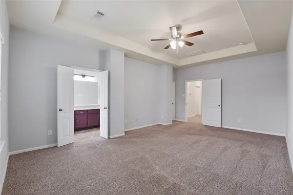 a view of an empty room with a ceiling fan