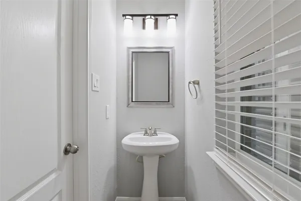 a bathroom with a sink a mirror and shower