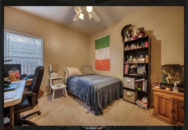 a bedroom with a bed and a desk in it