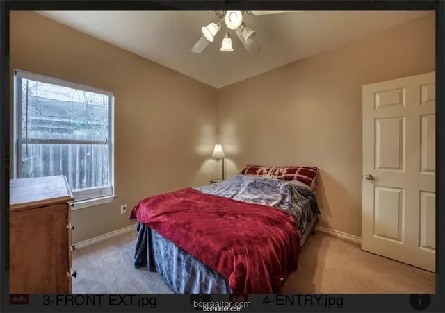 a bedroom with a bed and window