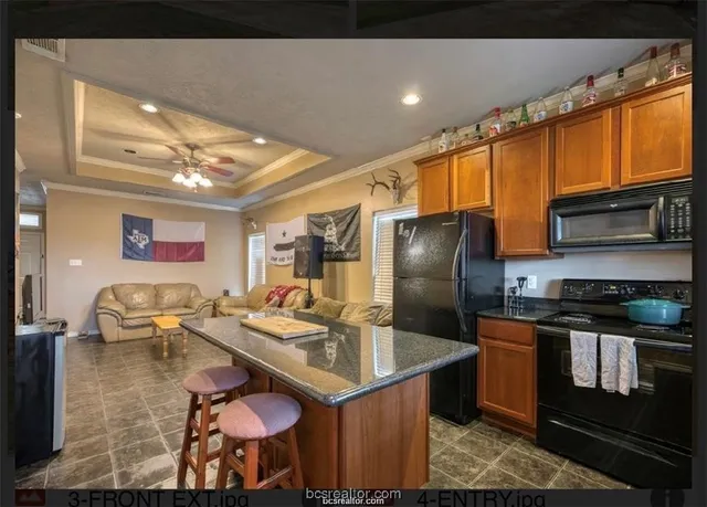 a kitchen with stainless steel appliances granite countertop a sink refrigerator and stove