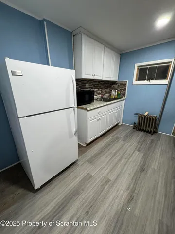 a white refrigerator freezer sitting in a kitchen