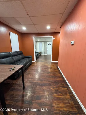 a view of a hallway with wooden floor