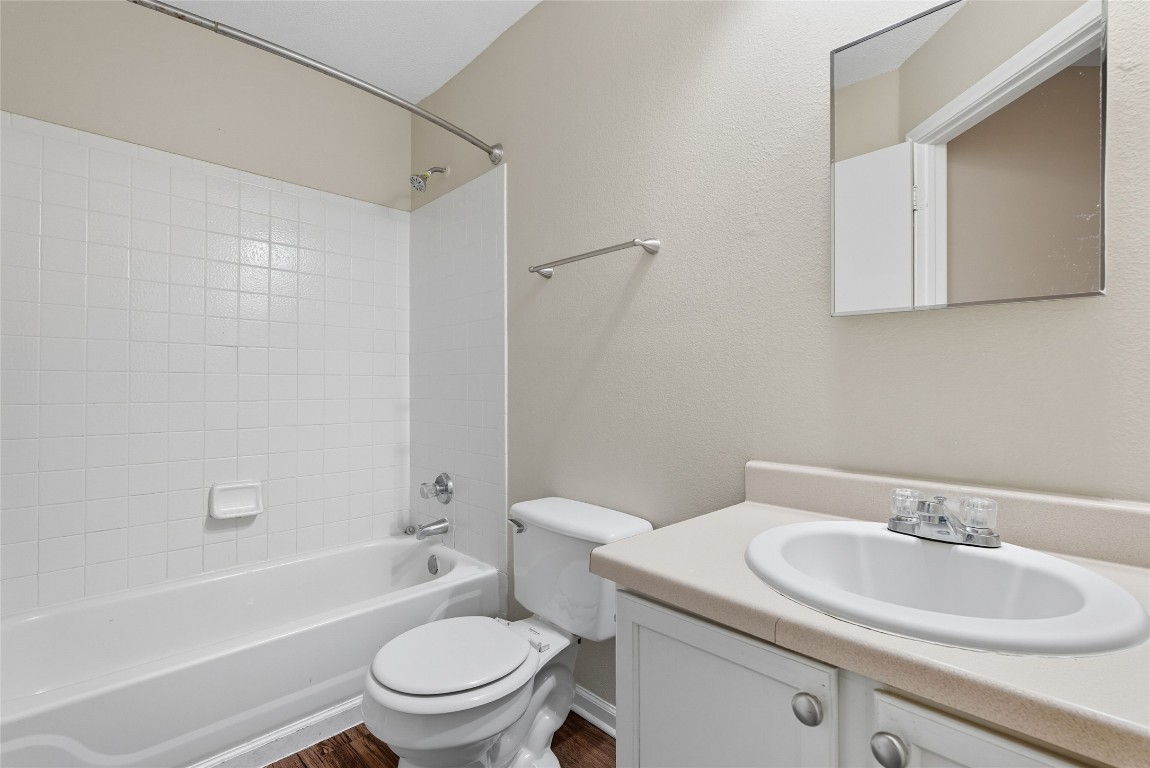 3621 Walleye Way Round Rock, TX 78665 - Photo 12 of 14 Bathroom featuring tub / shower combination, vanity, and dark wood-style flooring