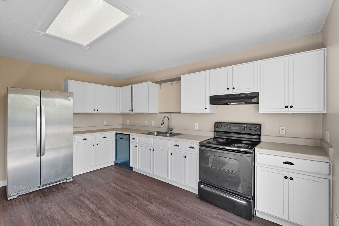 3621 Walleye Way Round Rock, TX 78665 - Photo 3 of 14 Kitchen featuring black appliances, white cabinets, light countertops, dark wood-style flooring, and under cabinet range hood
