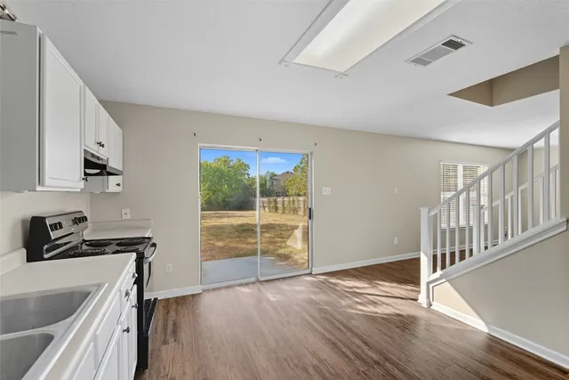 a view of a room with wooden floor and a sink