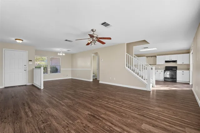 a view of an empty room with wooden floor