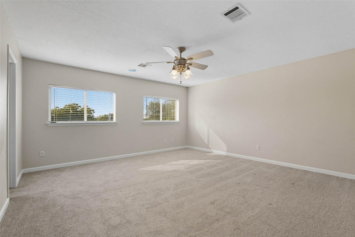 3621 Walleye Way Round Rock, TX 78665 - Photo 7 of 14 Empty room featuring light colored carpet and ceiling fan