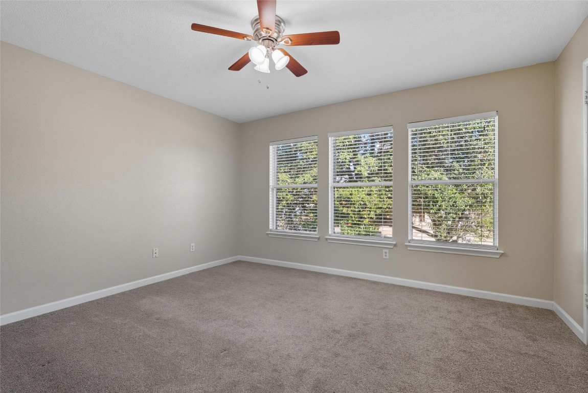 3621 Walleye Way Round Rock, TX 78665 - Photo 9 of 14 Spare room featuring light colored carpet and a ceiling fan