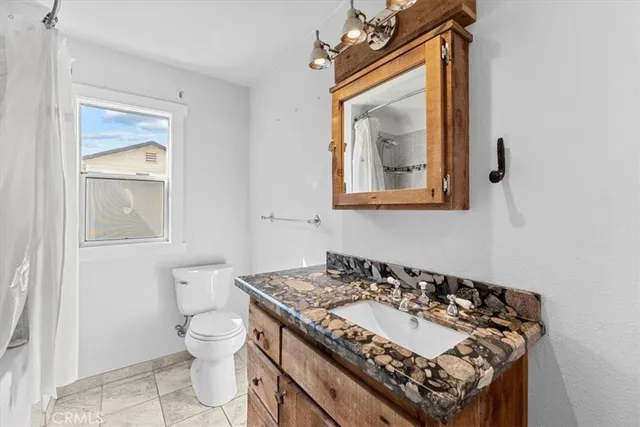a bedroom with a large bed and a potted plant