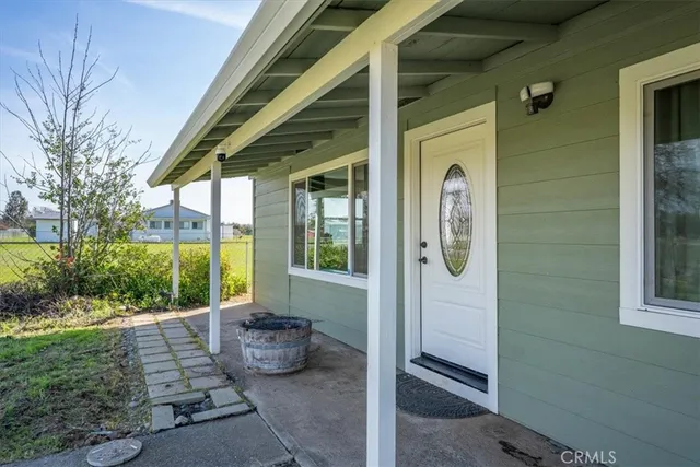 a view of a livingroom with wooden floor and a ceiling fan