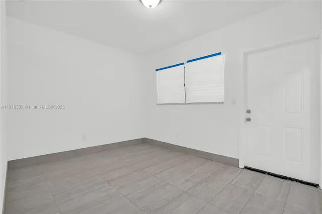 an empty room with wooden floor and closet