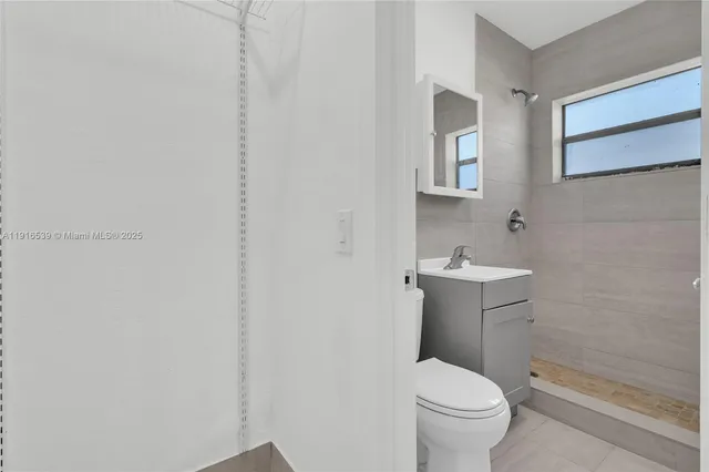 a white toilet sitting next to a bathroom sink