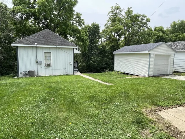 a front view of house with yard and trees