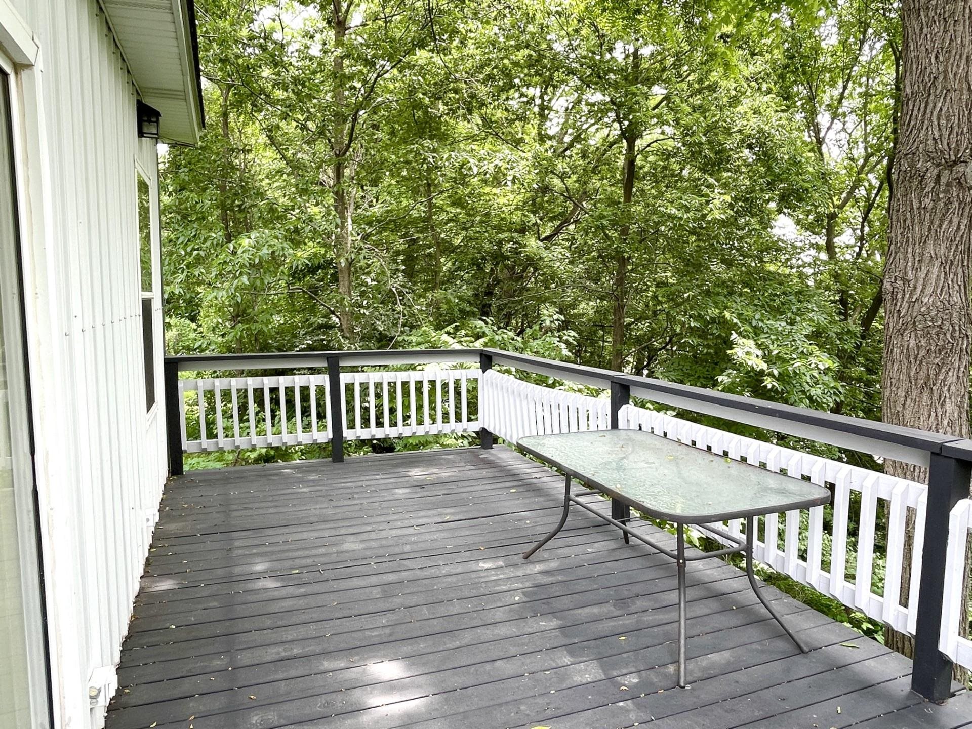 42 2nd Street LaSalle, IL 61301 - Photo 18 of 22 a view of a balcony with wooden floor and bench