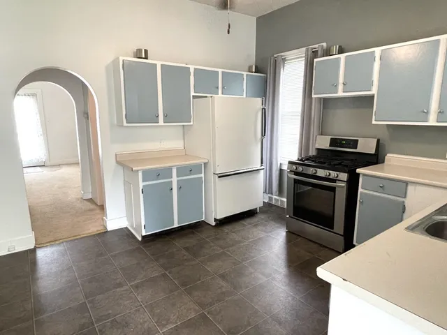 a kitchen with stainless steel appliances a refrigerator and a stove top oven