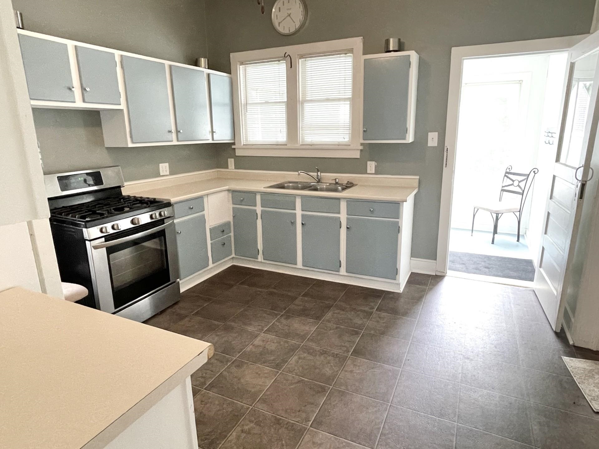 42 2nd Street LaSalle, IL 61301 - Photo 6 of 22 a kitchen with a stove a sink and a refrigerator