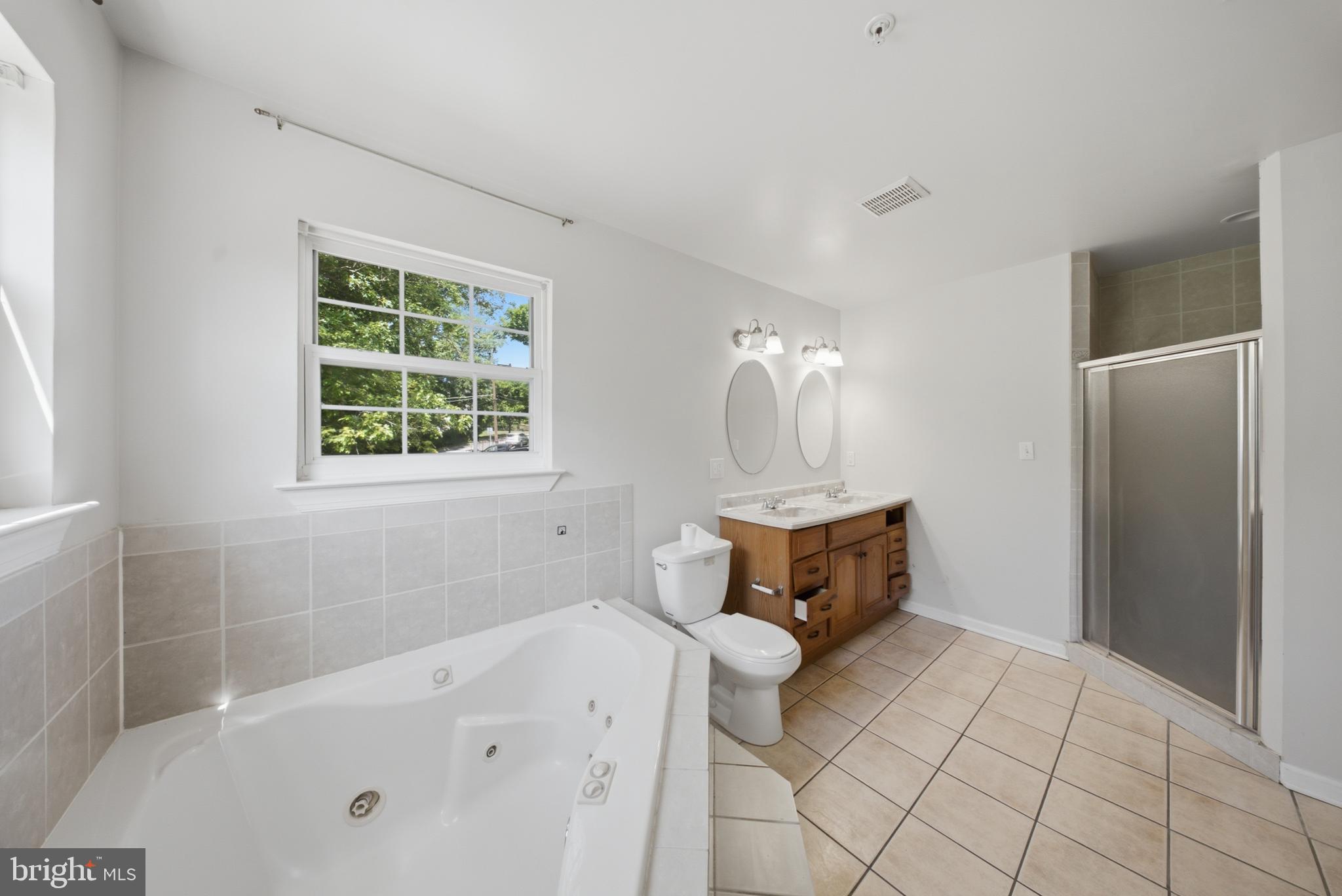 7611 Temple Hill Road Temple Hills, MD 20748 - Photo 13 of 25 a bathroom with a bathtub and a shower