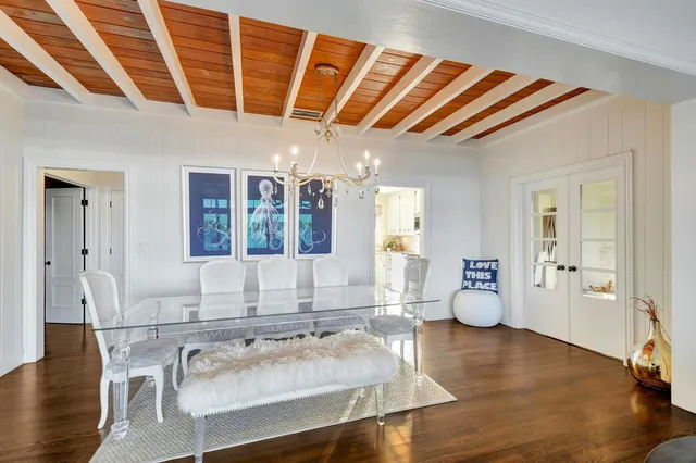 a living room with furniture and large windows