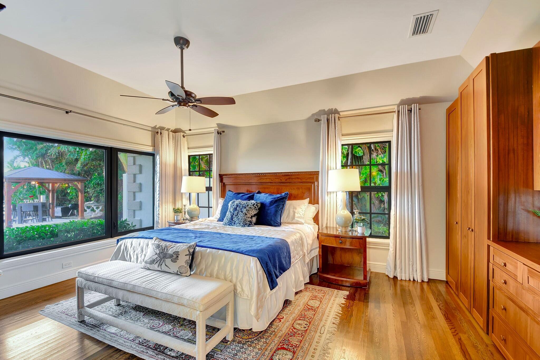 310 South Lake Drive Lantana, FL 33462 - Photo 23 of 65 a bedroom with a bed wooden floor and window