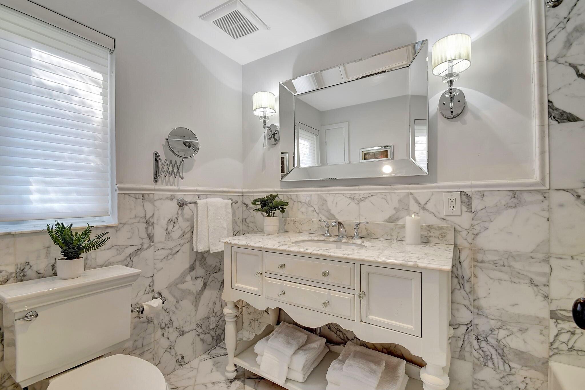 310 South Lake Drive Lantana, FL 33462 - Photo 26 of 65 a bathroom with a granite countertop toilet sink and mirror