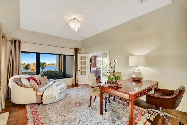 a bedroom with furniture and a large window