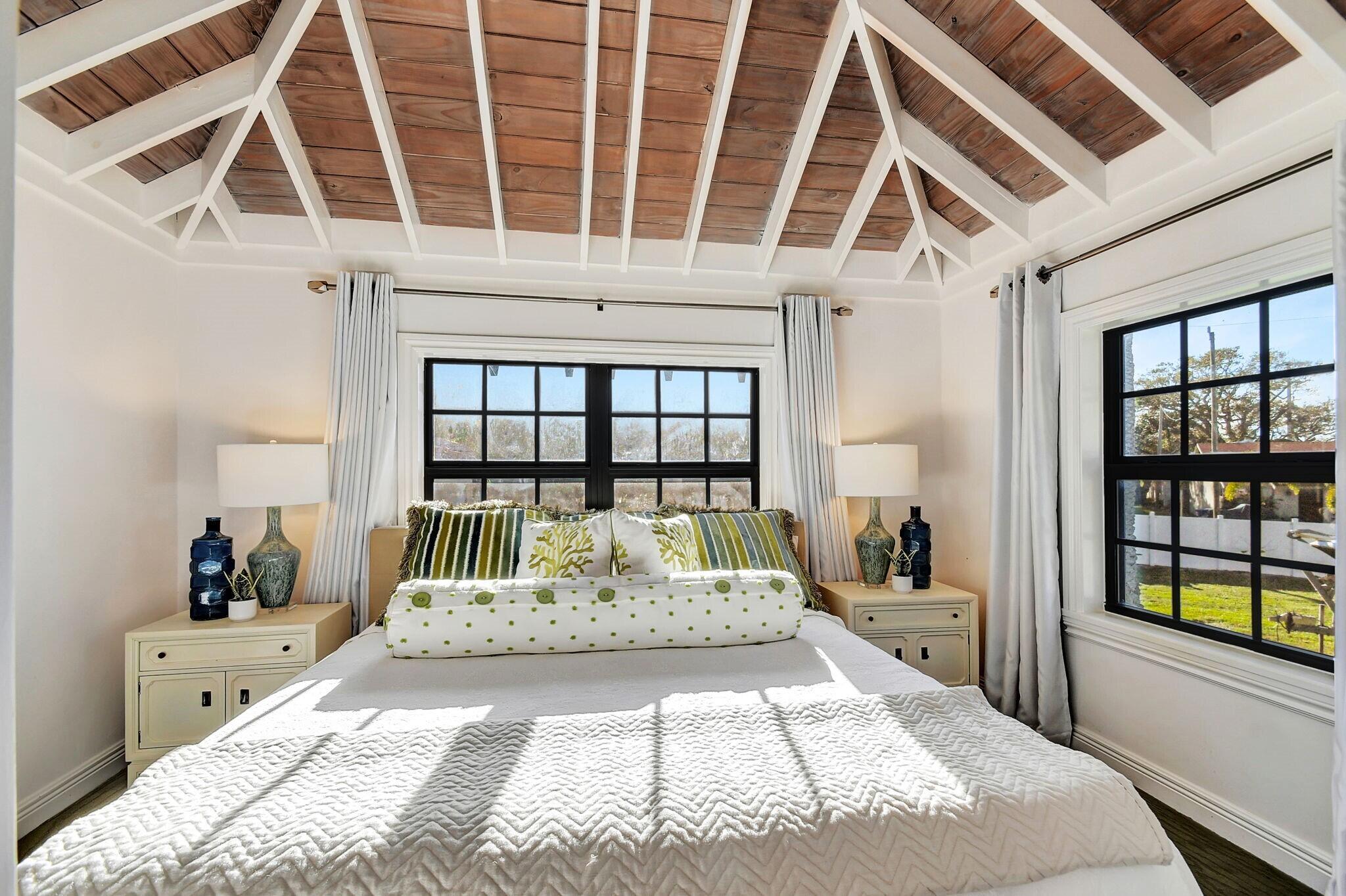 310 South Lake Drive Lantana, FL 33462 - Photo 33 of 65 a large bedroom with a large bed and a large window