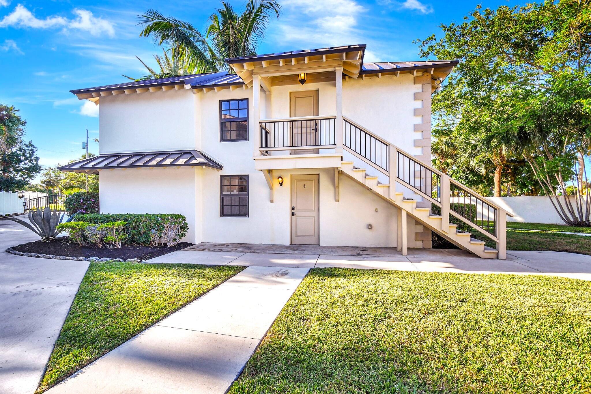 310 South Lake Drive Lantana, FL 33462 - Photo 37 of 65 a front view of a house with a yard
