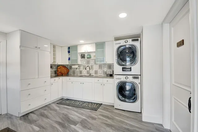 a patio with a table and chairs under an umbrella