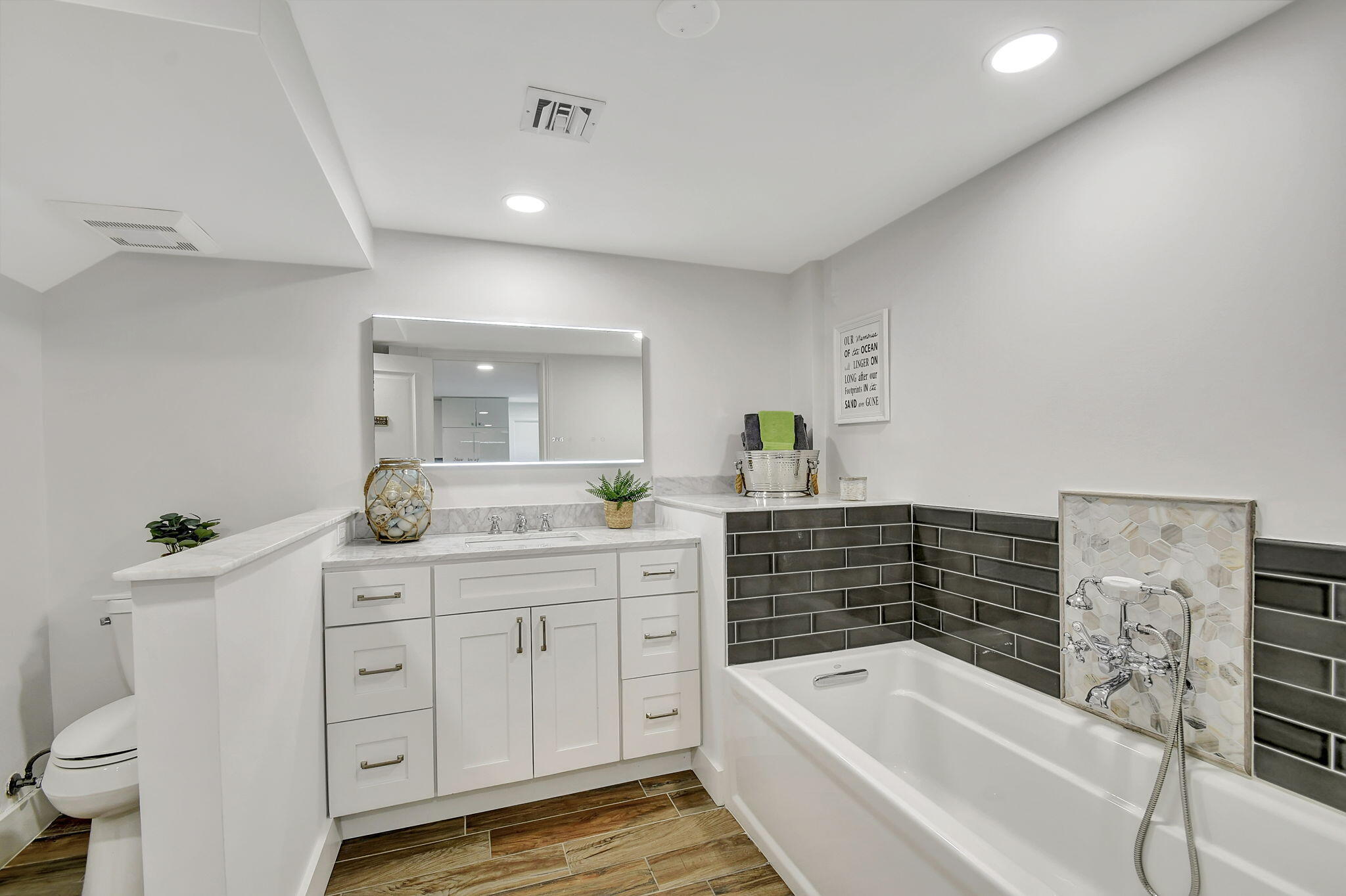 310 South Lake Drive Lantana, FL 33462 - Photo 40 of 65 a bathroom with a tub sink and mirror